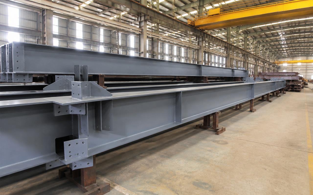Structural steel beams in a PEB fabrication facility